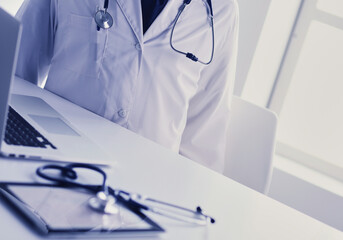 Wall Mural - Medical equipment: blue stethoscope and tablet on white background. Medical equipment