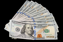 100 Dollar Bills Fanned On Black Background