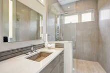 Contemporary Bathroom Interior With Walking Shower With Grey Tiles And Large Glass Door. Luxury New Home. 