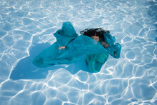 Fine Art Portrait Of Girl In Blue Green Dress Underwater In Swimming Pool