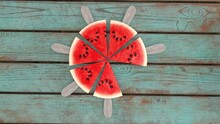 A Neatly Cut Watermelon On A Stick Against The Background Of A Wooden Table 3d-rendering