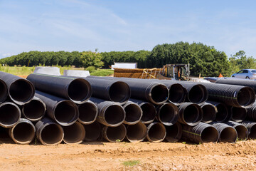 Wall Mural - View new black plastic pipes for the drainage system on new home construction site