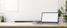 Laptop Mockup And Copy Space On Tabletop Over Blurred White Living Room In The Background