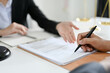 © bongkarn - Cropped, A male client signs his signature on the law contract in front of the lawyer