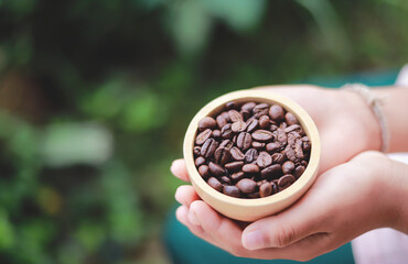 kid holding coffee bean in bowl for making drink in home. selective focus.