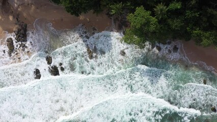 Wall Mural - Aerial drone footage of sea ocean waves reaching shore.Beach with aerial drone. Beach clear turquoise top view. Beautiful beach