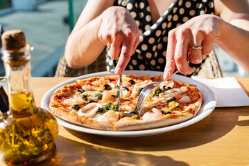 woman eating pizza in cafe