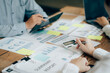 © Kritdanai - The atmosphere in the meeting room where the businessmen are meeting, information papers and charts are placed on the table to support the business planning meeting to grow. Business idea