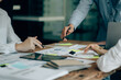 © Kritdanai - The atmosphere in the meeting room where the businessmen are meeting, information papers and charts are placed on the table to support the business planning meeting to grow. Business idea