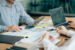 © Kritdanai - The atmosphere in the meeting room where the businessmen are meeting, information papers and charts are placed on the table to support the business planning meeting to grow. Business idea