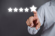 © jintana - Businessman pointing a five-star symbol to increase the company's rating, customer service and Satisfaction, positive customer Experience feedback and review