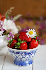 Wall Mural - A bowl with strawberries on the table.