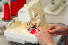 Older Lady's Hands Working At Sewing Machine