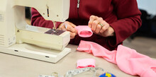 Sewing Machine With Lady Fitting Cuff To Garment