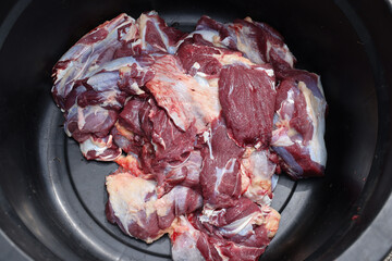 Making the process of tasty fresh beef meat. close up and texture of Traditional Red beef meat. Meat food background. White, blue, red, and black bucket