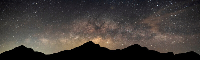 Wall Mural - silhouette mountain with milky way with stars in dark night background.dark night sky and many stars