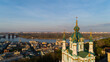 Aerial view Kyiv St. Andrews Church at beautiful sunset. Drone flies over old Kiev - podil. Andrews Descent