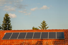 Row Of Solar Panels On Red Tiled Roof
