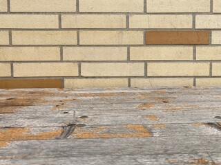 Wall Mural - a washed out wooden board stands in front of a light stone wall