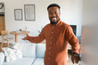 © Prostock-studio - Cheerful Black Guy Opening Door Standing At Home