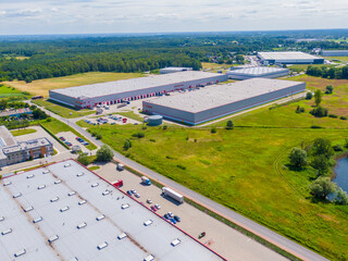 Wall Mural - Warehouse storages or industrial factory or logistics center from above. Aerial view of industrial buildings and equipment machines. Aerial view