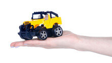 Yellow Toy Car In Hand On White Background Isolation