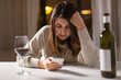 canvas print picture - alcoholism, alcohol addiction and people concept - drunk woman or female alcoholic with smartphone drinking red wine at home