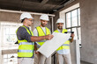 canvas print picture - architecture, construction business and people concept - male architects in helmets with blueprint and tablet pc computer working in office building