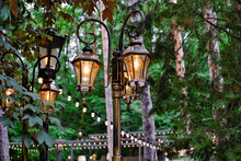 Retro Style Streetlights With Warm Illumination. Vintage Lantern In The City Park. Decorative Lighting System.
