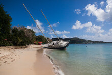 Abandoned Sailboat On The Beach Of Martinique Island In The Caribbean.