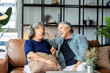 old senior asian retired age marry couple wellness lifesstyle together at home,old people laugh smile together with love and bonding on sofa in living room home interior background