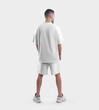 Mockup of white sportswear, t-shirt and oversized shorts on a man in sneakers, blank clothing for design, pattern, advertising, back view.