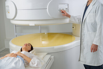 Wall Mural - Woman patient is ready to do magnetic resonance imaging MRI or CT scan in clinic