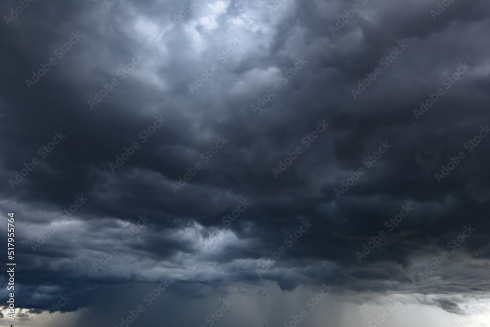 The dark sky with heavy clouds converging and a violent storm before ...