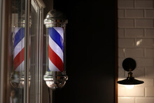 Barber Shop Vintage Pole. Copyspace Barbershop. Barber Shop Pole In Red White And Blue With Lightbulb On Top.