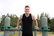© Евгений Шемякин - Young handsome fit athletic strong man is training doing triceps and chest pull ups in park on sports ground outdoors on bar at summer. Open air gym. Bodybuilding, fitness sport healthy lifestyle.