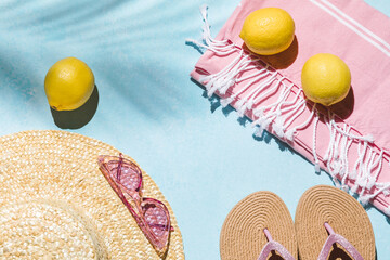 Summer flat lay with straw hat, sunglasses and beach accessories on blue background with palm leaf shadow, sun and sunlight. Vacation, holiday, summer creative concept, copy space, banner.