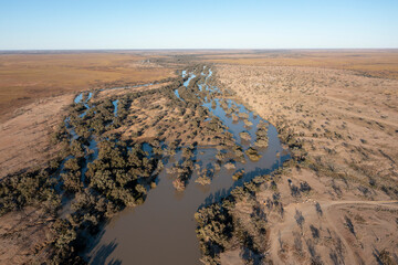 Wall Mural - Flood waters flowing down Cooper creek in western Queensland heading towards Lake Eyre.