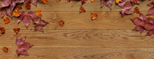 Seasonal Wallpaper, With Fall Leaves On Natural Wood Surface. Thanksgiving Concept With Space For Text.