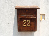 Fototapeta Tęcza - An old wooden mailbox hangs on a white wall. Galle, Sri Lanka