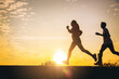 © Panumas - Silhouette of young couple running together on road. Couple, fit runners fitness runners during outdoor workout with sunset background.