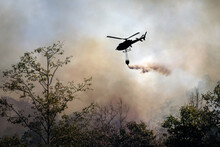 Fire Fighting Helicopter Dropping Water Onto Wildfire