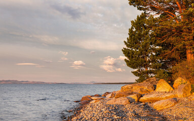 Wall Mural - Shore of Baikal Lake in the early morning at dawn. Natural background. Beautiful summer landscape