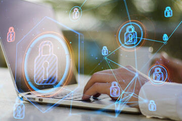 Poster - businessman hands using laptop at desktop with coffee cup and abstract glowing connected digital padlock hologram on blurry outdoor background. Computer safety and secure concept. Double exposure.