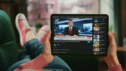 Point of View First Person Using Tablet Computer Watches Mock-up Television Channel Live TV News Program. Anchors Talking, Reporting, Analyzing Events. Mock-up Video Sharing Social Media Platform