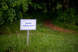 Fototapeta Londyn - a sign informing about the boundaries of the area for women in the meditation center