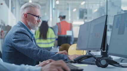 Leinwandbilder - Portrait of a Middle Aged Industrial Engineer Developing Models of a Heavy Industry Machine Parts on Computer 3D Software in a Factory. Modern Technological Research and Development Center. Arc Shot.