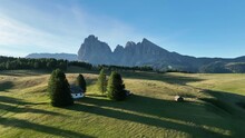 Aerial View Of Seiser Alm Plateau With Traditional Wooden Mountain Cottages On The Meadows In Dolomites Mountains In Italy. Morning Drone Shot Of Idyllic Alpe Di Suisi Blooming Meadow In South Tyrol.