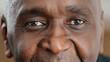 Close up part male face happy elderly African American man smiling with friendly dark black eyes. Handsome mature senior citizen with wrinkles looking blink wink with eye friendly eyesight good vision