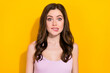 Photo of worried young lady biting lip look camera isolated on bright yellow color background